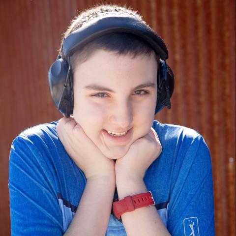 Gage smiling with his fists to his chin