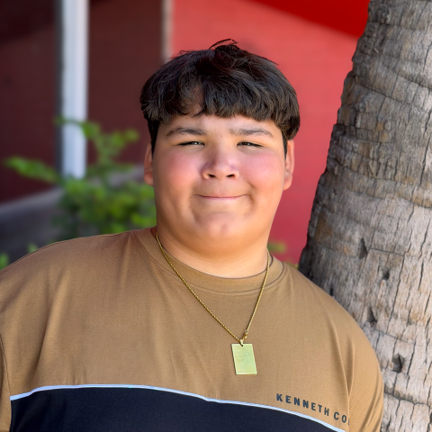 Jayden leaning on a tree